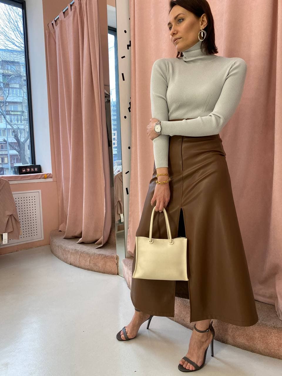 Elegant outfit with a grey turtleneck and brown leather skirt, catalogued in a digital wardrobe
