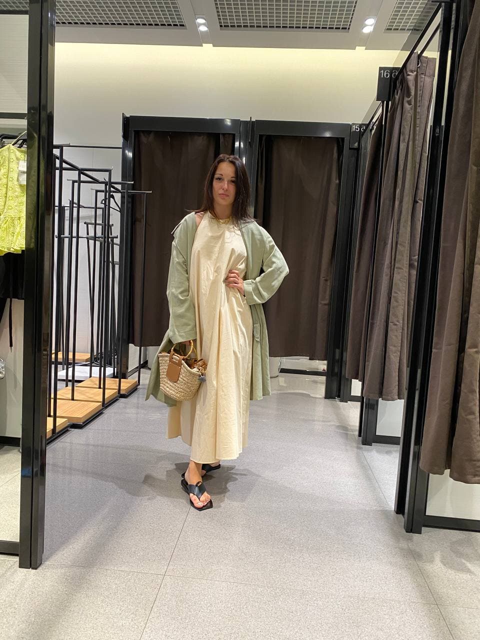 Light travel outfit with a cream dress and sage green coat