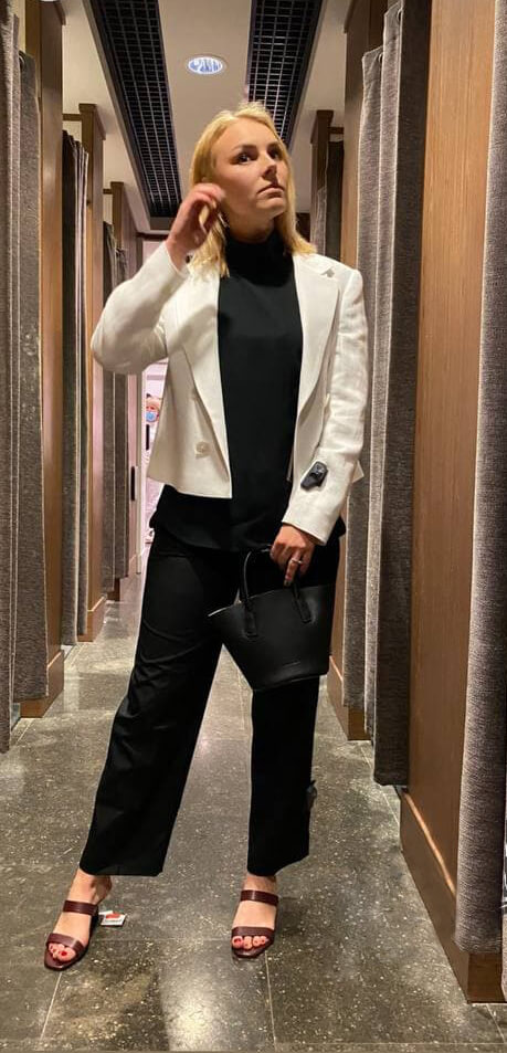Office look with a white cropped blazer over a black outfit
